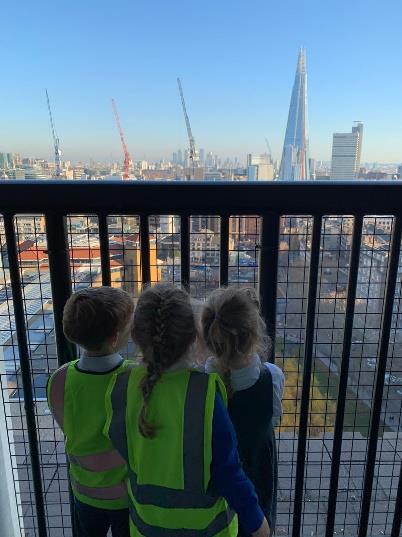 Children looking over the London skyline