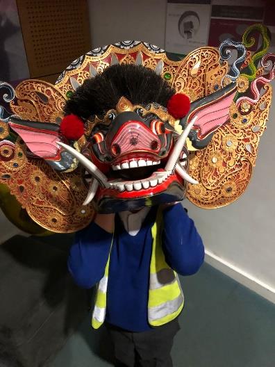 Child wearing a Barong mask